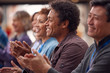 © Monkey Business - Group Of Casually Dressed Businessmen And Businesswomen Applauding Presentation At Conference