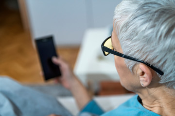 Poster - Mature Woman Using Blue-Light Blocking Glasses in the Evening to Minimize Sleep Disruption