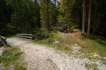 Wall Mural - A tourist on a bench by the trail cleans shoes