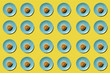 © Sasha - Sweet buns in blue plate isolated on yellow. Top view. Sweet cinnamon rolls pattern. hard shadow