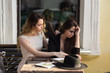 © Nickolay - A friend calms a distressed friend because of a recent setback.