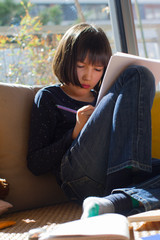 Wall Mural - child drawing or studying, learning while class shutdown at home