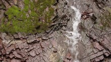 Small Stream Of Water Running Down Rock Face