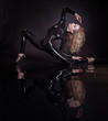 Junge, blonde Frau posiert akrobatisch in Latexanzug 