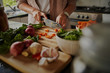 © StratfordProductions - Closeup of young female hands chopping fresh vegetables on chopping board while in modern kitchen - preparing a healthy meal to boost immune system and fight off coronavirus