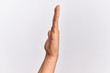 © Krakenimages.com - Hand of caucasian young man showing fingers over isolated white background showing side of stretched hand, pushing and doing stop gesture