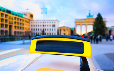 Wall Mural - Taxi sign board in street of Berlin Brandenburg gate reflex