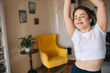 © Anatoliy Karlyuk - People, lifestyle, leisure and technology concept. Happy overjoyed plus sized teenage girl enjoying social distancing, listening to music in earphones, dancing, being carefree and full of energy