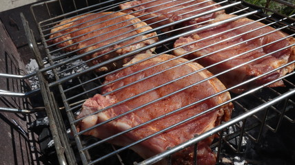 Pork steaks cooked on a charcoal grill outdoors