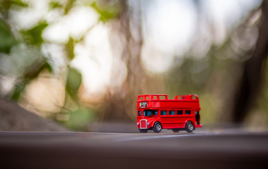 toys that represent two of the main symbols of the city of London, double-decker bus on blurred background. selective focus and grain nose.