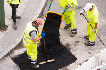 construction site with workers for road maintenance, potholes and paving resurfacing