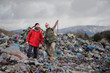 © Halfpoint - Man and woman hikers on landfill, environmental concept.