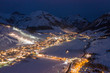 © Westend61 - Italy, Province of Sondrio, Livigno, Aerial view of illuminated town in Italian Alps at dusk