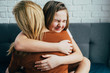 Mother day. Beautiful young woman and her charming little daughter are hugging and smiling. mom gently hugged her daughter, the girl snuggles up to her cheek with squinting facial expression.