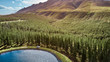 © Westend61 - South Africa, Western Cape, Swellendam, Aerial view of 4x4 car driving along lakeshore at edge of forest