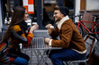 © Yakobchuk Olena - Coffee to go for two friendly people in street cafe stock photo