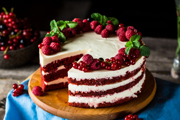 Red velvet cake on wood board. Slice of cake. Raspberry cake. Devil's cake. Wedding dessert. Birthday party. Delicious dessert. Traditional american dessert.