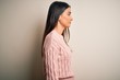 © Krakenimages.com - Young beautiful brunette woman wearing casual sweater over isolated white background looking to side, relax profile pose with natural face with confident smile.