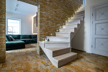 Stylish Wooden Contemporary Staircase Inside Loft House Interior. Modern Hallway With Decorative Limestone Brick Walls And White Oak Stairs.