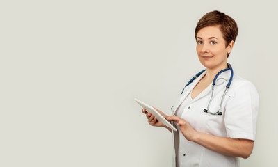 Portrait of a female doctor using her digital tablet. Female doctor using tablet and checking with analysis