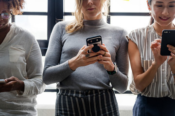 Canvas Print - Group of diverse people using smartphones