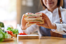 Closeup Image Of A Female Chef Cooking And Showing A Whole Wheat Sandwich In Kitchen