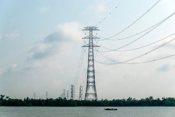 Electric pole crossing river in Mekong Delta. Vinh Long, Vietnam.
