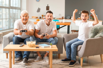 Canvas Print - Man with his father and son playing video games at home