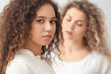 Wall Mural - Beautiful young women on light background