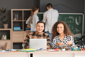 Poster - Young people at physics lesson in classroom