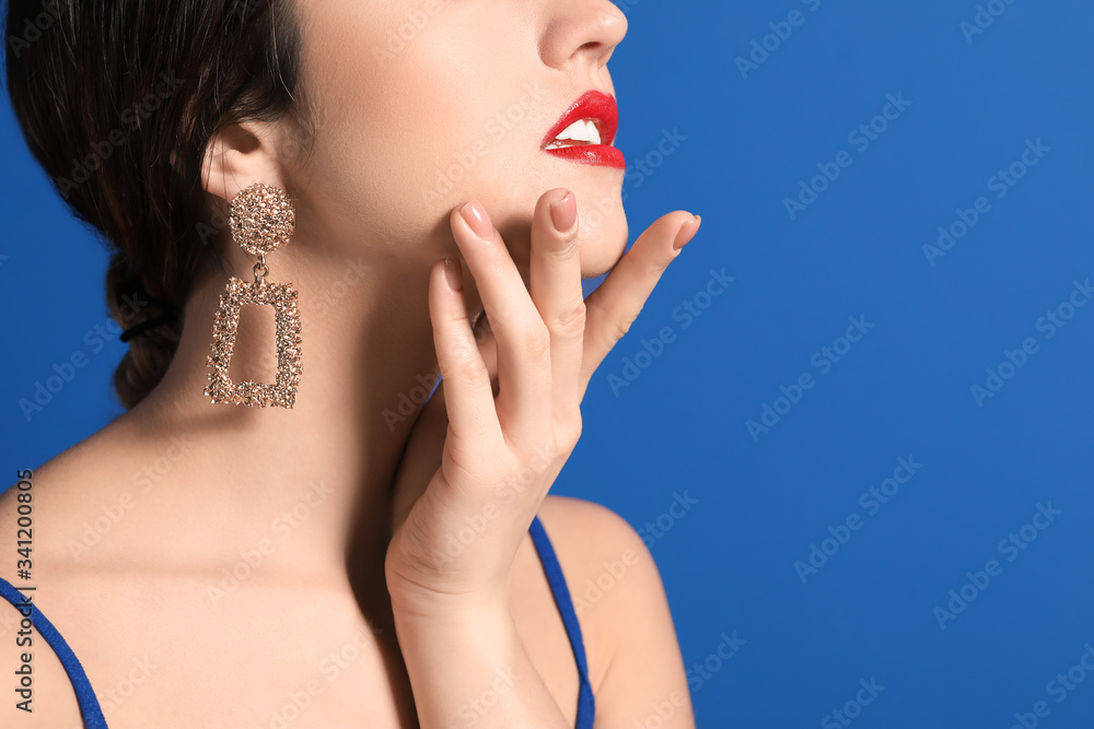 Fashionable young woman on color background