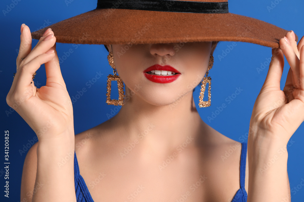 Fashionable young woman on color background