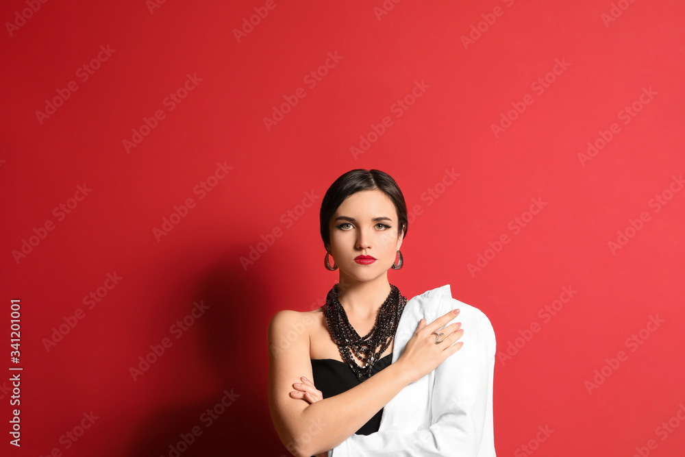 Fashionable young woman on color background