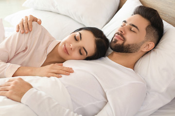 Wall Mural - Young couple sleeping in bed at home