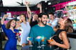 © JackF - Man with young female are enjoying the party in bar.