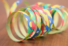 Close-up Of Multi Colored Paper Stripes On Table