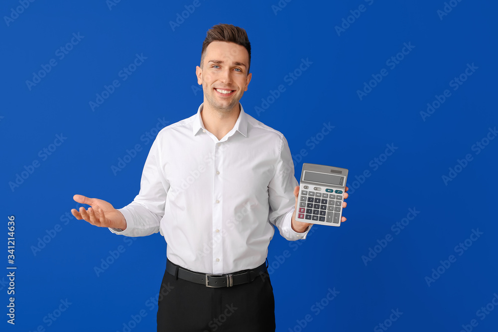 Young man with calculator on color background