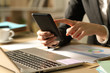 © PheelingsMedia - Entrepreneur hands using phone at night at home