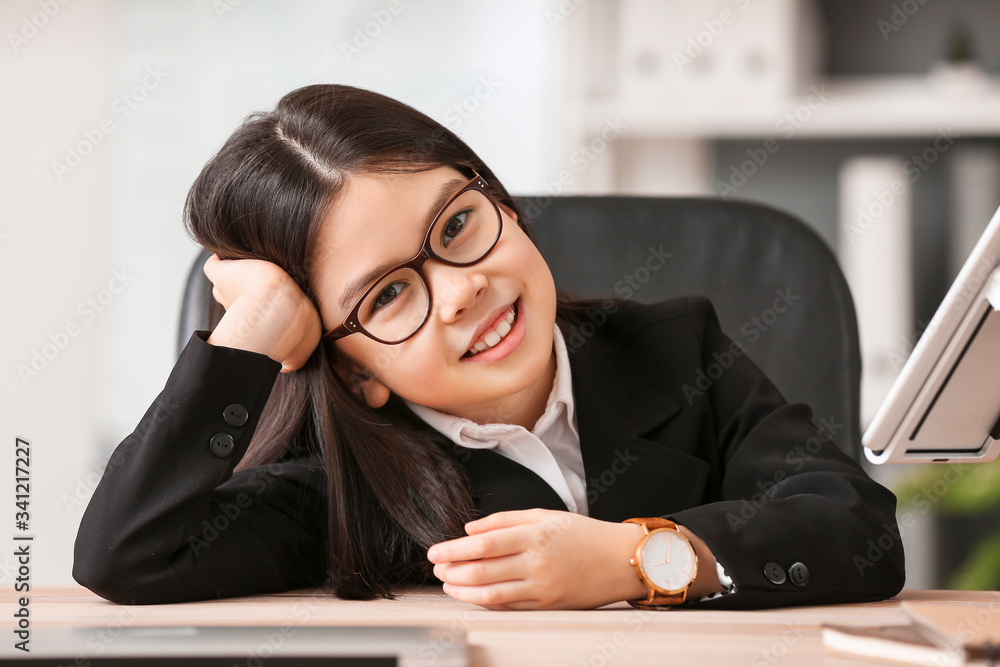 Cute little businesswoman in office