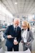 © JustLife - Colleagues working on project. Team of architects discussing business in factory.
