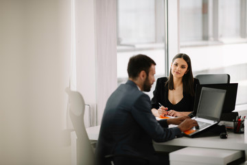 Wall Mural - Colleagues working together at the office. Businessman and businesswoman preparing for the meeting.	