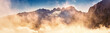Dachstein Panorama mit stimmungsvollen Wolken im Vordergrund und blauem Himmel