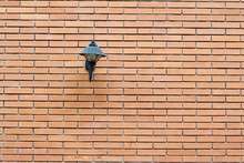 Low Angle View Of Street Light On Brick Wall