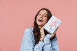 © Drobot Dean - Image of delighted young woman holding birthday present box