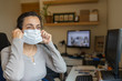 © Arpad - Middle aged pretty woman with protective mask working at home due to coronavirus quarantine