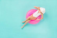 Full Length High Angle Top Above View Photo Of Gentle Lady Bronze Skin Sitting Swimming Pool Big Life Buoy Wear Sun Hat White Swim Bodysuit Isolated Pastel Teal Color Background