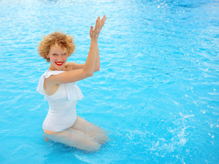 Wall Mural - beautiful smiling redhead (ginger) woman portrait enjoying life in the swimming pool in the summer day. Summer, relax, wellness, travel, recreation concept