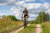 A man on a bicycle.
