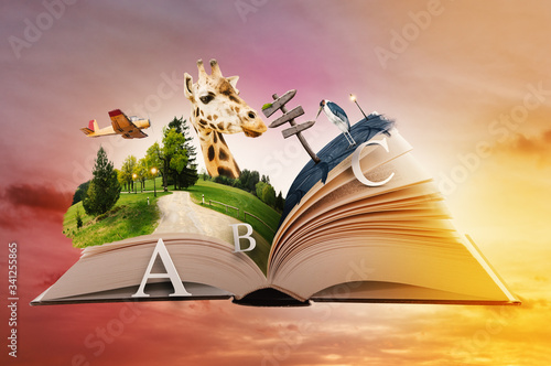 Photographie Flying Open Book with Animals, Paper Cut Letters and Magic Landscapes
