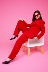 Wall Mural - Fashion model in red suit and sunglasses.